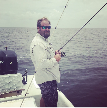 Captain-Ryan-fishing-pole Captain Ryan on a cloudy day with his favorite fishing pole.